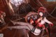 A woman in a red and black outfit sitting on a chair.